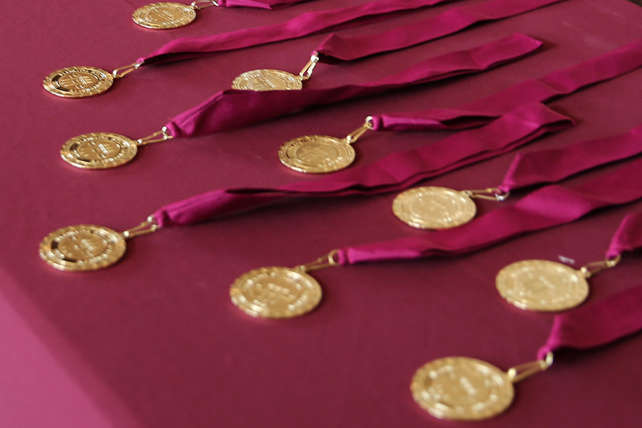 Photo of Honors Medallions on garnet table cloth. Link to FSU News article on the record number of Honors Graduates during the Spring 2020 semester. Photo credit: Andrew Myers, Division of Undergraduate Studies.