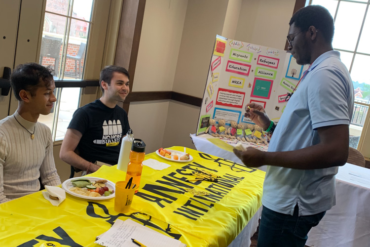 Fall 2019 Activism & Advocacy Fair-Student visiting the Amnesty International Table