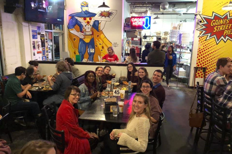 Movie Night-Captain Marvel-Large group photo at table,  eating pizza at Gaines Street Pies